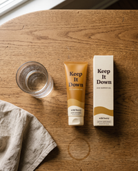 Keep It Down tube and carton side by side on an oak table, wild berry, 150 ml